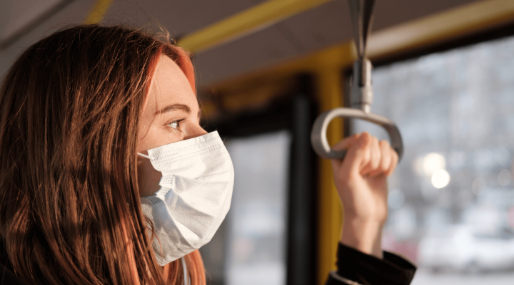 Woman in mask on public transport